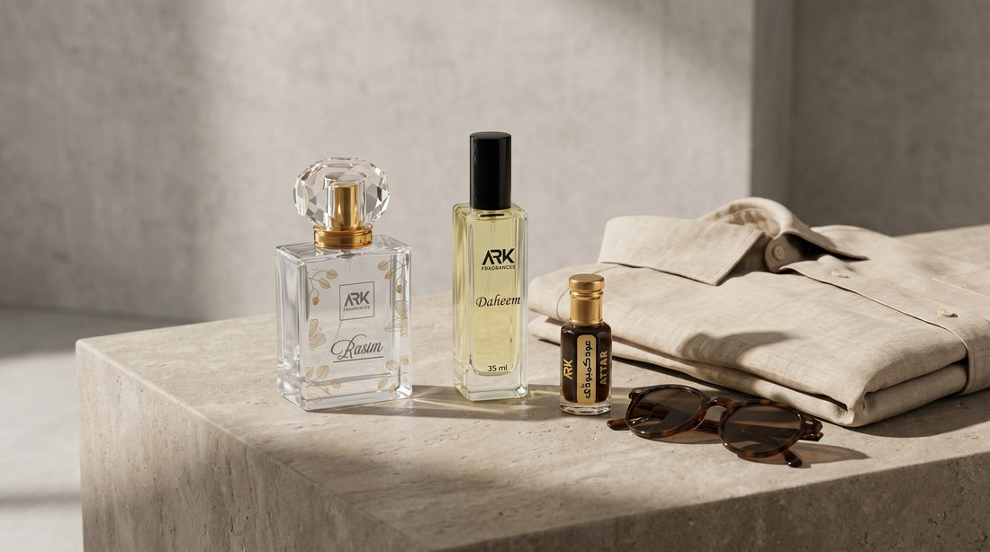 Three luxury perfume bottles placed next to a folded linen shirt and sunglasses, representing a minimalist fragrance wardrobe for men.