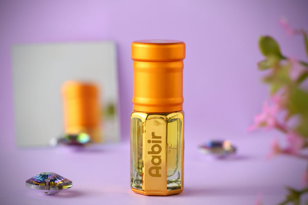 Aabir Attar by ARK Fragrances 3ml premium concentrated perfume oil in gold bottle displayed on purple background with crystals best luxury scent online delivery in Lahore Karachi Islamabad Faisalabad and Pakistan