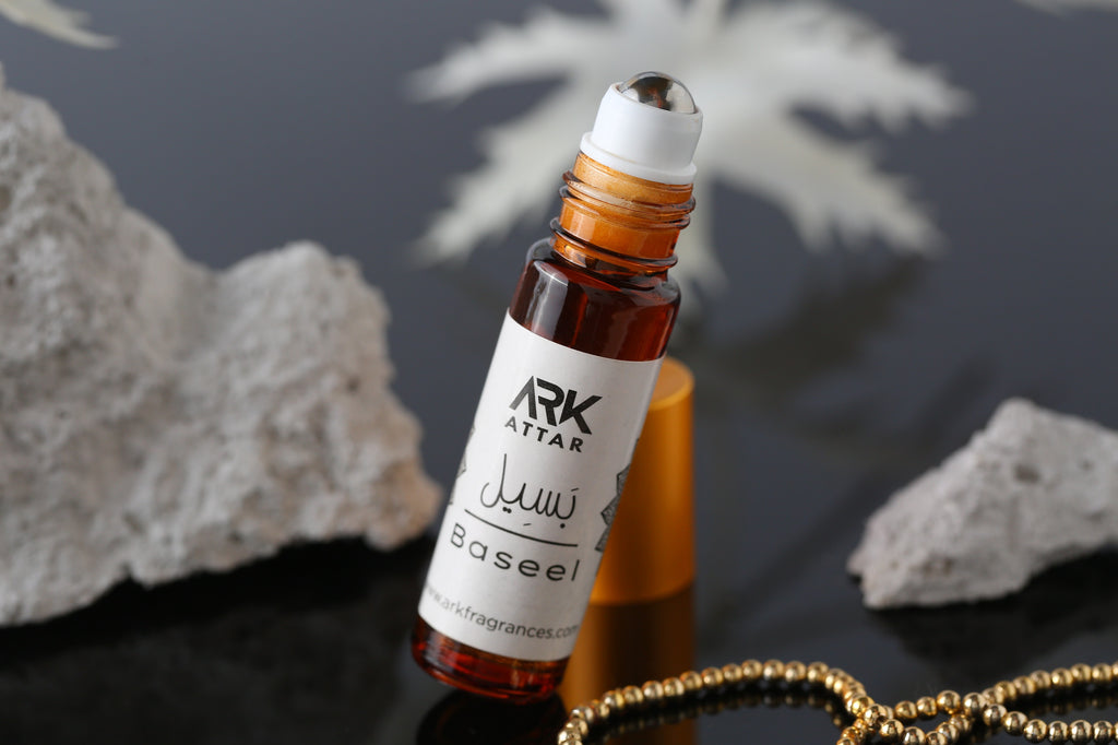 Baseel Attar by ARK Fragrances 6ml roll-on. Features spicy floral top notes with a rosy musky heart and a woody Agarwood Oud base. Premium alcohol-free perfume oil with beautiful mandala packaging for nationwide delivery in Pakistan.