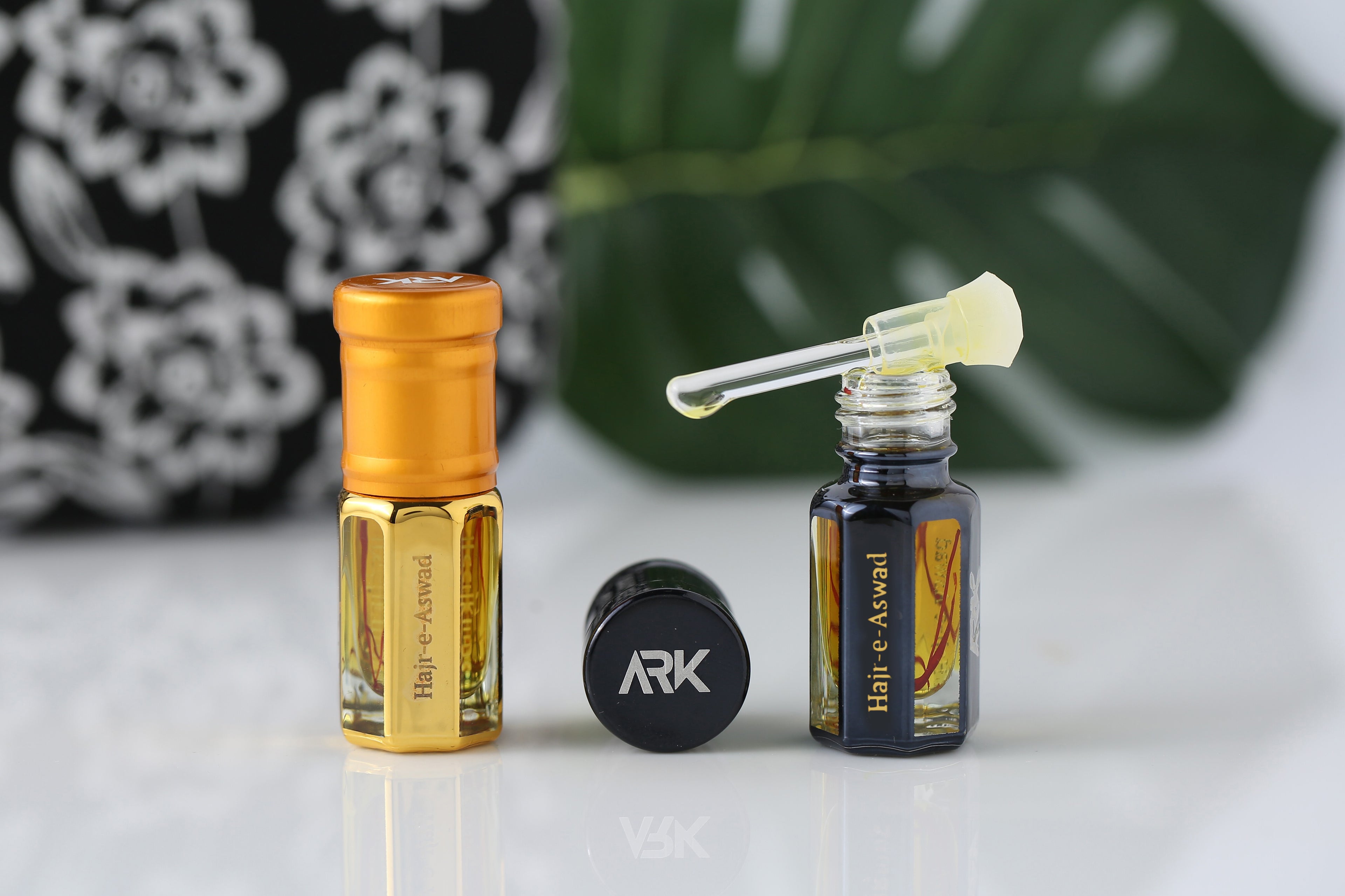 Hajr e Aswad Attar by ARK Fragrances premium concentrated perfume oil in gold and black bottles with glass stick applicator best Islamic gift online delivery in Lahore Karachi Islamabad Faisalabad and Pakistan