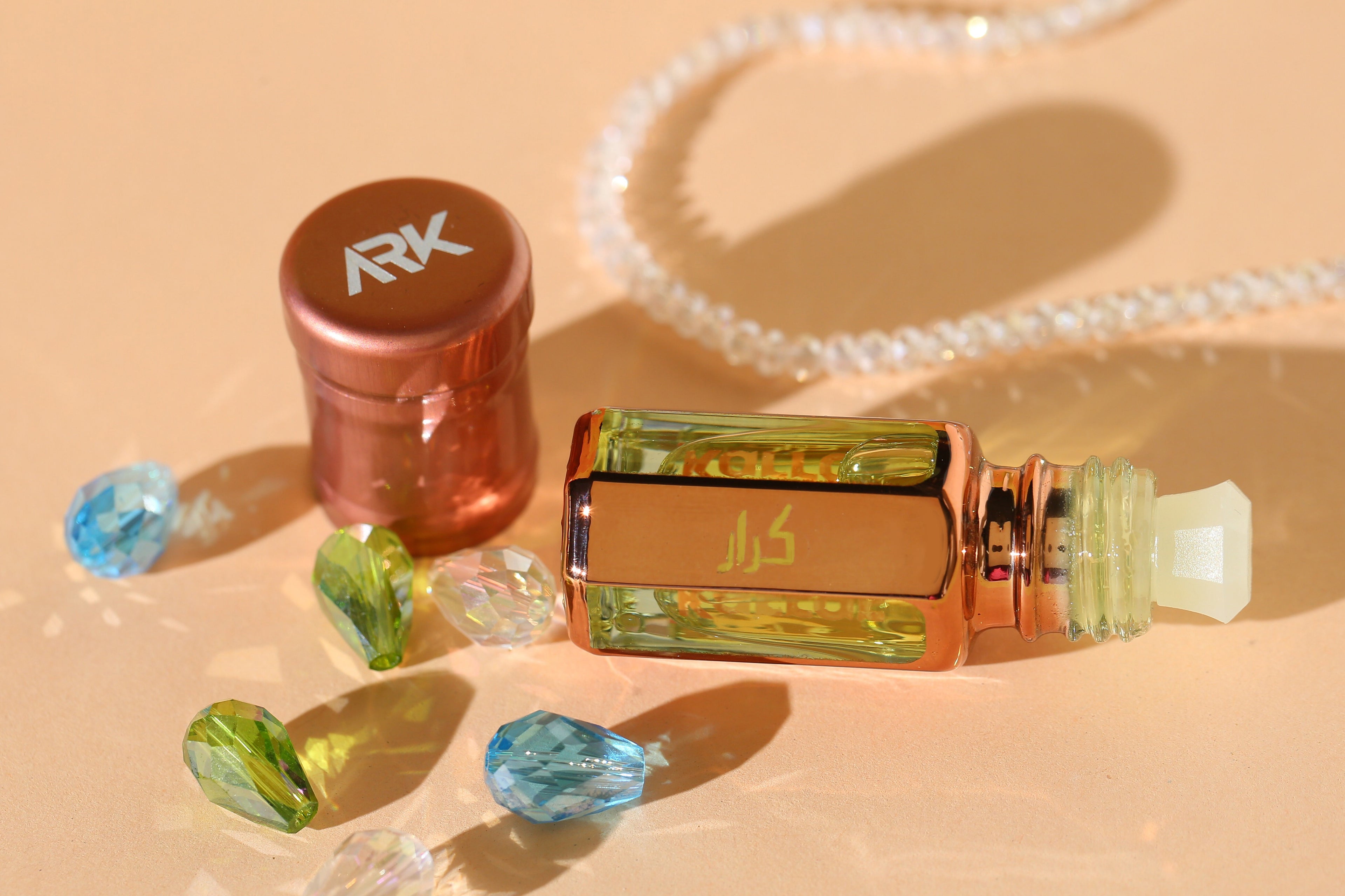 Karrar Attar by ARK Fragrances premium concentrated perfume oil displayed with luxury crystals and pearls alcohol free available in 3ml 6ml and 12ml sizes best gift for wedding