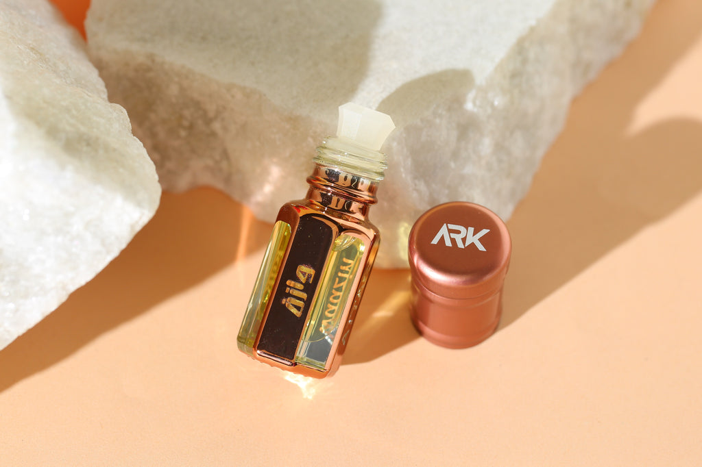 Waazin Attar by ARK Fragrances 3ml premium concentrated perfume oil displayed with glass stick applicator on white natural stones. A sophisticated fragrance featuring elegant notes of Lilies, Violets, and Vanilla, blended with White Musk and Honey. This long-lasting Oud-based scent is perfect for daily wear. We provide original attar delivery in Karachi, best selling perfume in Lahore, luxury fragrance in Islamabad, and fast shipping to Rawalpindi, Multan, Peshawar, and nationwide across Pakistan.