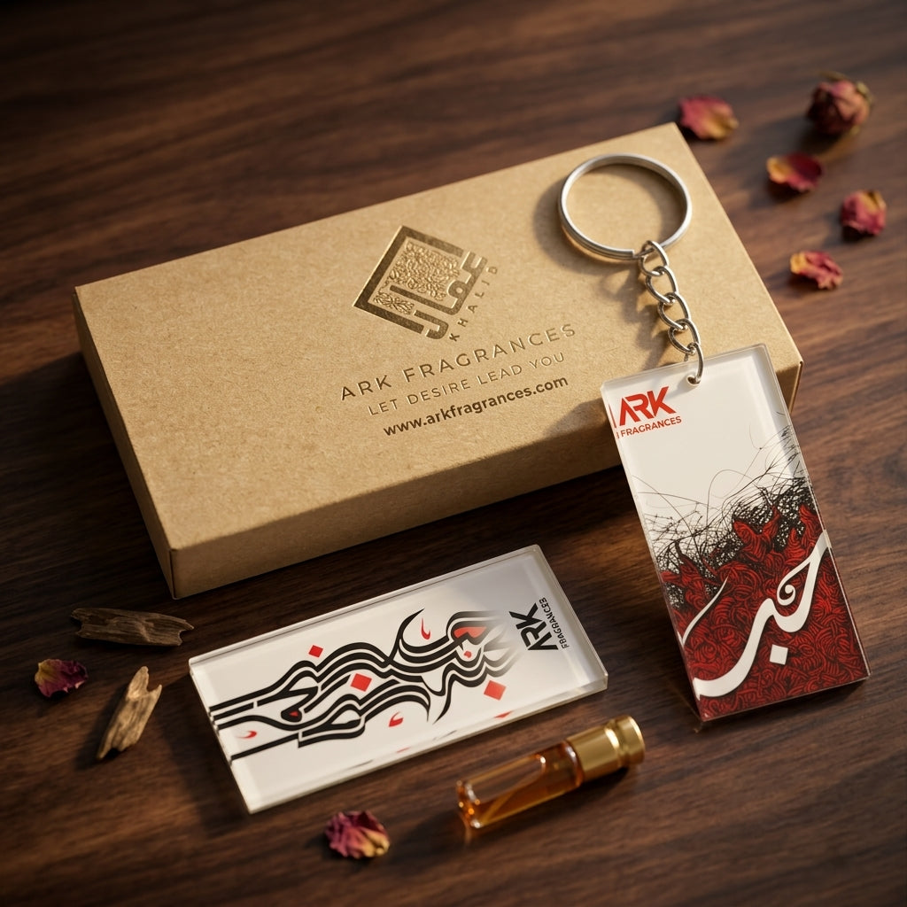 Premium acrylic calligraphy keychain featuring the Arabic word Hubb (Love) in red and black, placed next to a luxury ARK Fragrances gift box.