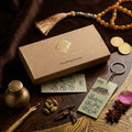 Premium acrylic calligraphy keychain with traditional earthy green design, placed next to a luxury ARK Fragrances kraft gift box, tasbeeh, and calligraphy pen.